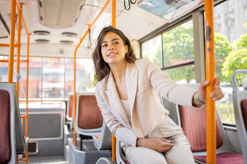 Happy young woman riding public transportation