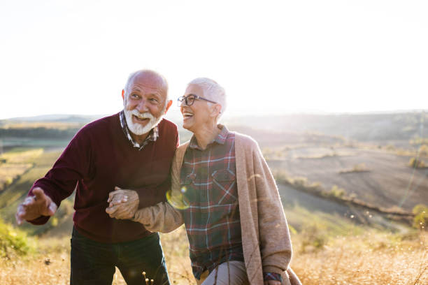 istock Happy mature couple walking on a hill. 1497146173