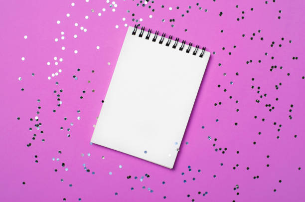 istock Blank Notepad on Purple Background and Confetti, Top View 1497148170