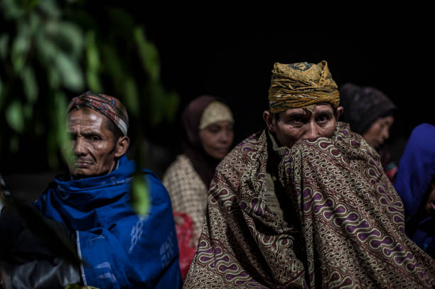 PROBOLINGGO, EAST JAVA, INDONESIA - August 11, 2014 : Tenggerese gather at crater of Mount Bromo during the Yadnya Kasada Festival on August 11, 2014 in Probolinggo, East Java, Indonesia. The Tenggerese people are a Javanese ethnic group in Eastern Java who claim to be the descendants of the Majapahit princes. The origin of the festival lies in the 15th century princess named Roro, the principality of Tengger with her husband Joko Seger, and the childless couple asked the mountain Gods to help in bearing children. The legend says the Gods granted them 24 children but on the provision that the 25th must be added to the volcano in sacrifice. The 25th child, Kesuma, was finally sacrificed in this initial after refusal, and the tradition of throwing sacrifices into the Caldera to appease the mountain Gods continues today.