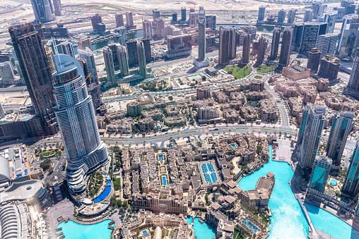 Dubai, March 14. 2019 - Aerial view of Dubai skyscrapers in downtown district. With the main street Sheikh Zayed road. View over the skyscrapers to the little houses of the workers. View to Hotel areas