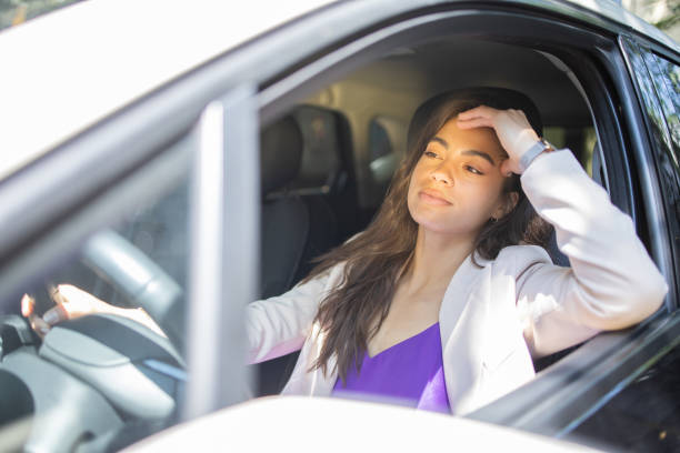 istock Woman is driving a car on her way to work 1497151002