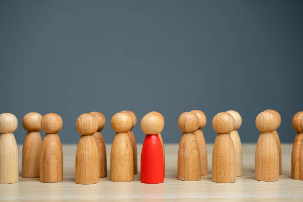 istock The red man steps forward from the group. Volunteer. Enterprising person. A special leader and promising head of the team. Courage, confidence and passion for new challenges. 1497152143