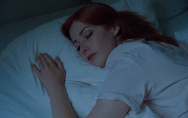 istock young woman asleep in bed at night 1497156825
