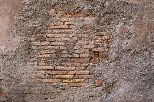 Grunge Roman wall texture with visible bricks in the historic center of Rome