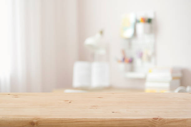 istock Wooden table top with blurred modern student room background 1497159753