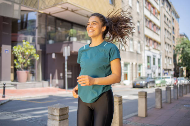 istock Young woman is jogging outside 1497160428