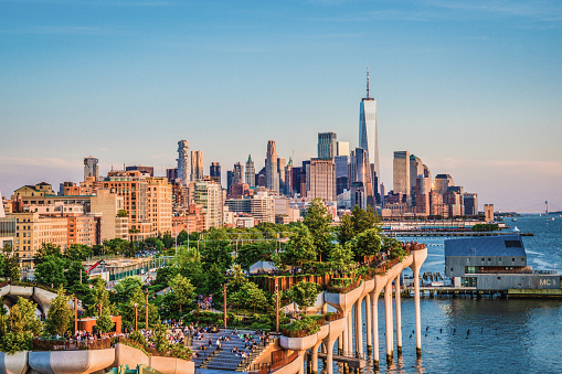 A shot of Little Island from the Chelsea district in New York with the Manhattan skyline in the background