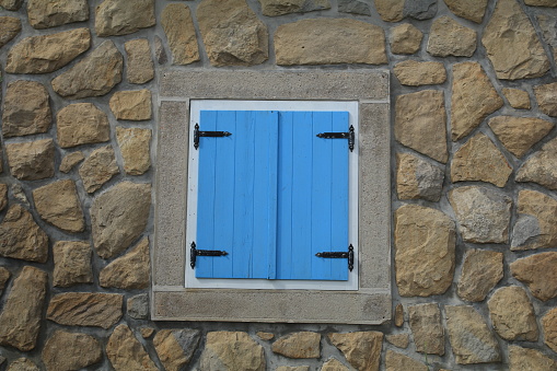 Blue wooden shutter sun protection in the window in house in Croatia