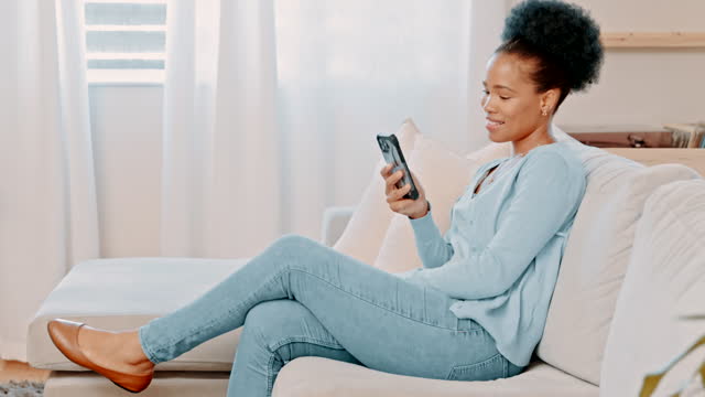 Relax, social media and woman with phone on a sofa for internet, browsing and entertainment in her home. Smartphone, app and day off with girl on a couch happy, smile and laughing and online post