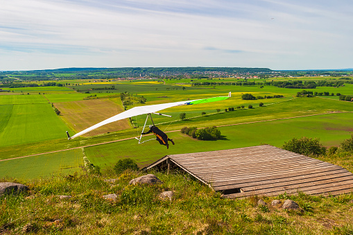 Falköping, Sweden-June, 2018: Hang gliding flying in a beautiful rural landscape