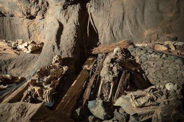 ancient communal tomb in a cave, with ancient human skeletons resting