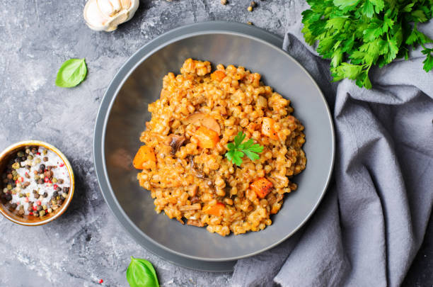 istock Spelt Pumpkin Mushroom Risotto on Grey Background, Vegetarian Meal 1497168452