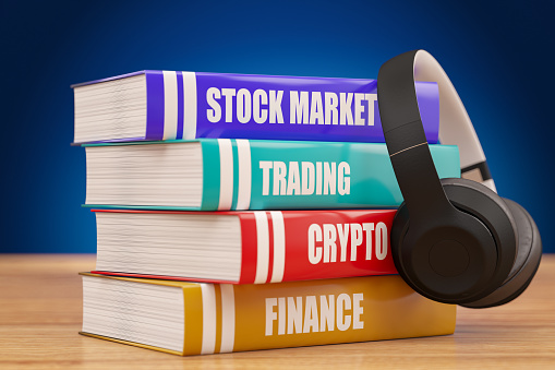 Stock Market Trading Crypto and Finance Books Financial Education Books  with a Headphone. 3D Render