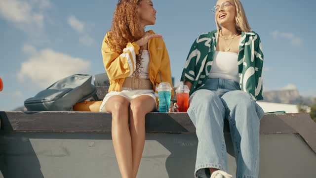 Gen z, girl and friends at a skatepark with smoothie, conversation and bonding on the weekend outdoors. Freedom, chilling and females with drink, youth and speaking outdoors, hanging out and relax
