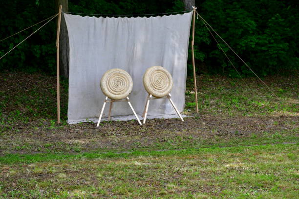 istock A view of a temporary shooting range prepared for an archery and crossbow competition with targets made out of rolled hay on wooden stands with the background being a cloth hanging from two sticks 1497172596