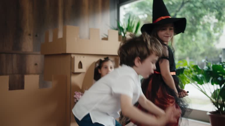 Princess, Prince And Witch Playing Role Play Game At Home With Castle Made Of Cardboard