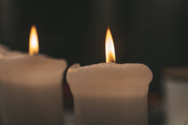 istock Close-up of a table with lit candles, illuminated in warm light 1497180664