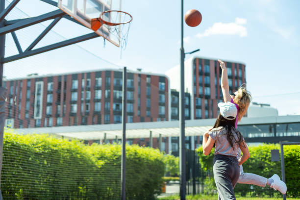istock Mother and daughter playing basketball. 1497181705