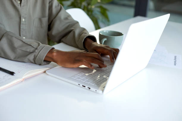 istock Closeup of hands using laptop at a desk in the office 1497182519