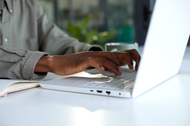 istock Closeup of hands using laptop at a desk in the office 1497182525