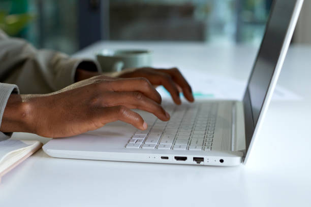 istock Closeup of hands using laptop at a desk in the office 1497182729