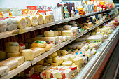 Delicious variety of cheese in the dairy aisle refrigerated section of the supermarket