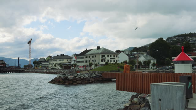Man Walking at City Pier Enjoying Fjord View in Norway