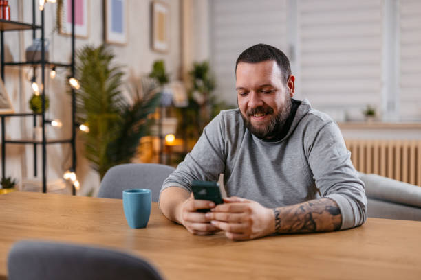 istock Young Man Holding His Phone With A Smile On His Face 1497187512