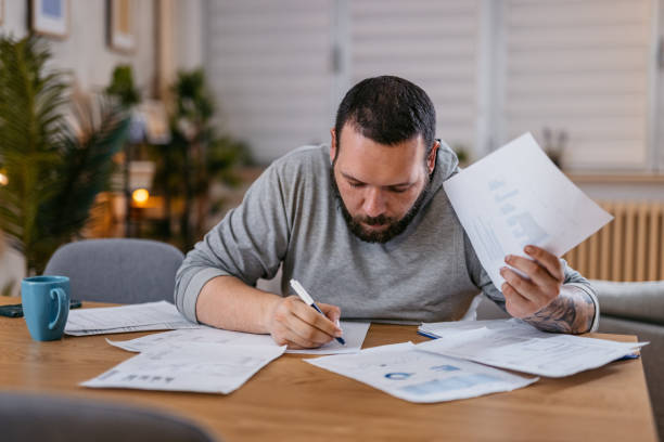 istock Man Checking Personal Finances at Home 1497188691