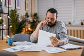 Man Checking Personal Finances at Home