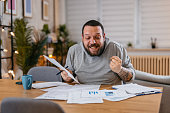 Man Checking Personal Finances at Home