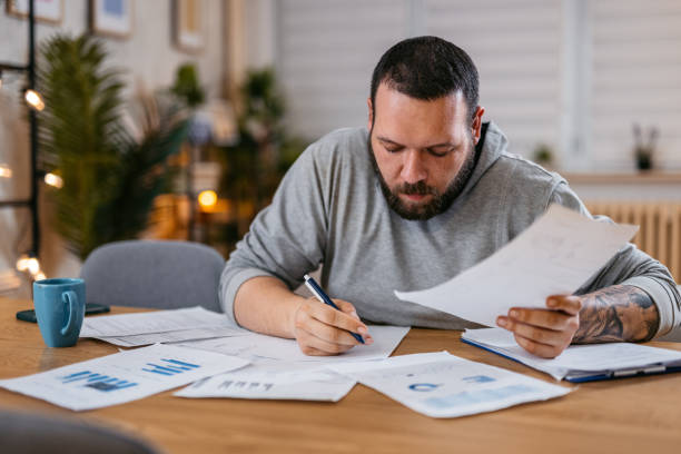 istock Man Checking Personal Finances at Home 1497188951