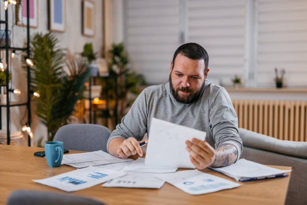 istock Man Checking Personal Finances at Home 1497189023