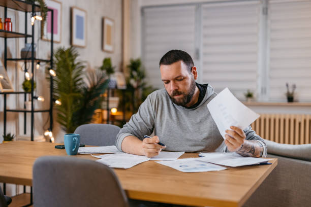 istock Man Checking Personal Finances at Home 1497189068