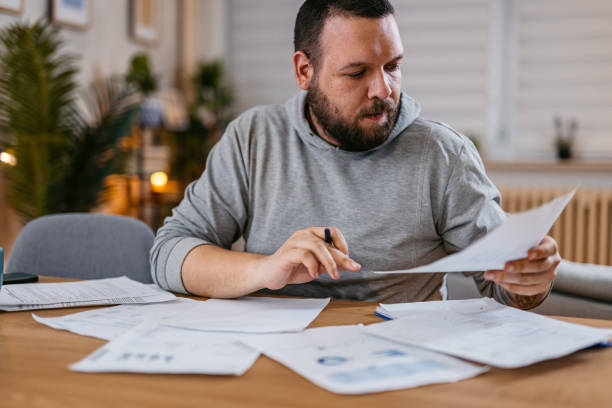 istock Man Checking Personal Finances at Home 1497189288