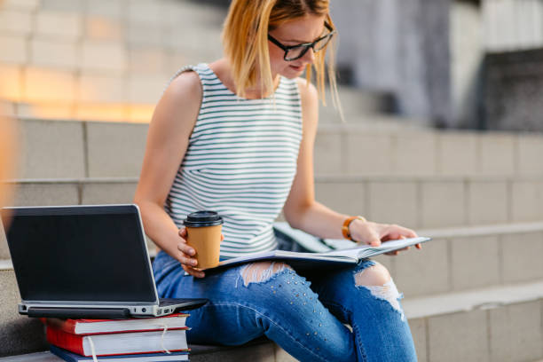istock Female Student Studying And Having A Coffee Time 1497190966