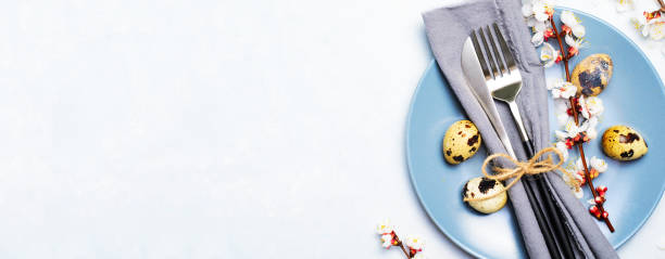 istock Easter Table Setting with Quail Eggs and Branches in Blossom, Spring Holidays Background 1497191139