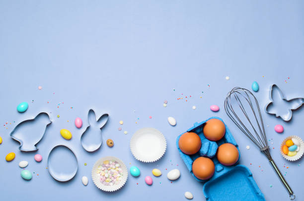 istock Easter Concept, Cookie Cutters, Eggs, Sugar Sprinkles and Chocolate Eggs on Bright Background 1497193736