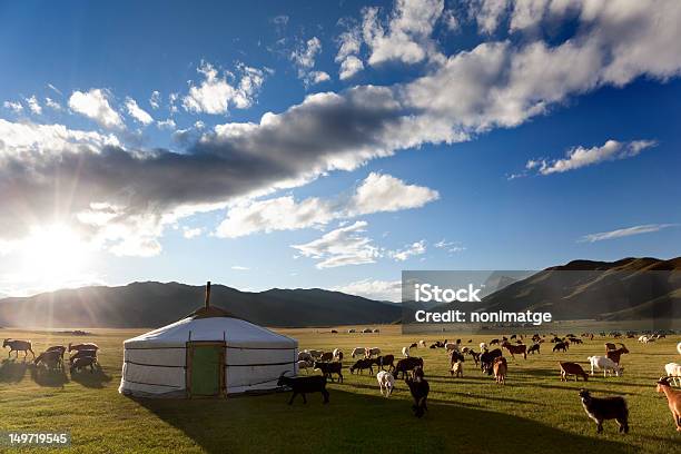 Livestock In A Pasture Around Haystack On Partly Cloudy Day Stock Photo - Download Image Now