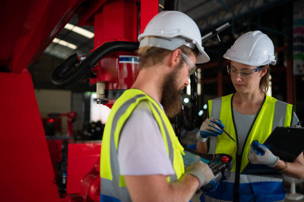 istock Both of engineers installing and testing a large robotic arm. before sending it to customers for use in the industry 1497197881
