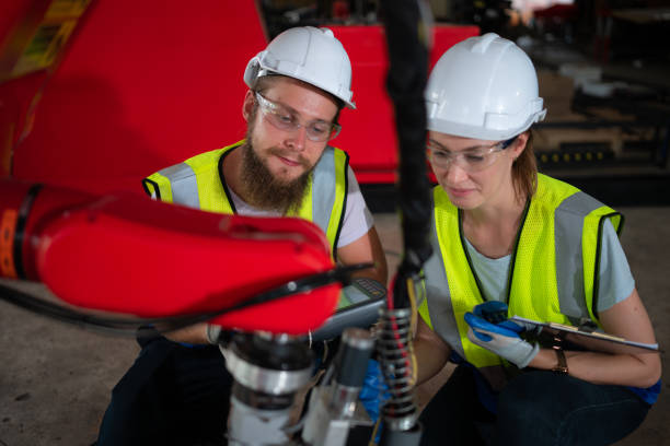 istock Both of engineers installing and testing a large robotic arm. before sending it to customers for use in the industry 1497197886