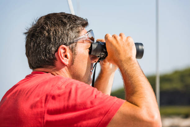 istock Sailor with binoculars on sailboat 1497198241