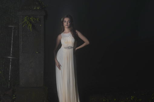 Lifestyle Young Indian woman in cream color evening gown in mystical environment of Forest. Mystical environment of Matheran