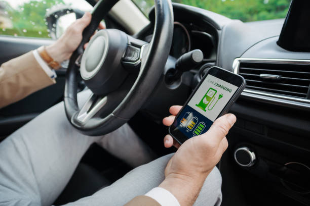istock Close up of businessman using electric vehicle charging app, checking electricity usage and the nearest charging station. 1497199057