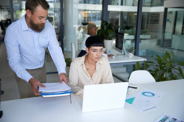 istock Boss comes in with more work to unhappy employee 1497202479