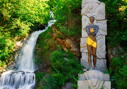 Monument to Prometheus near a waterfall in Borjomi Park, Borjomi Georgia.