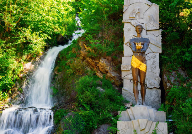 monument to prometheus near a waterfall in borjomi park, borjomi georgia. - xxx imagens e fotografias de stock