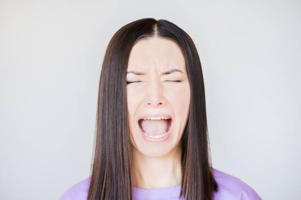 istock woman opening her mouth, crying, screaming, experiencing stress strong negative emotion 1497206640