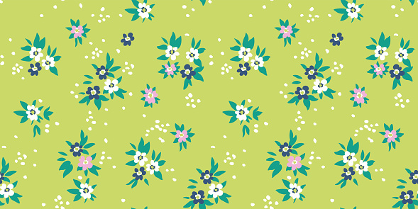 Seamless pattern of abstract white, blue and pink flower buds with white dots on a light green background. Great for decorating fabrics, textiles, gift wrapping, printed products, advertising.